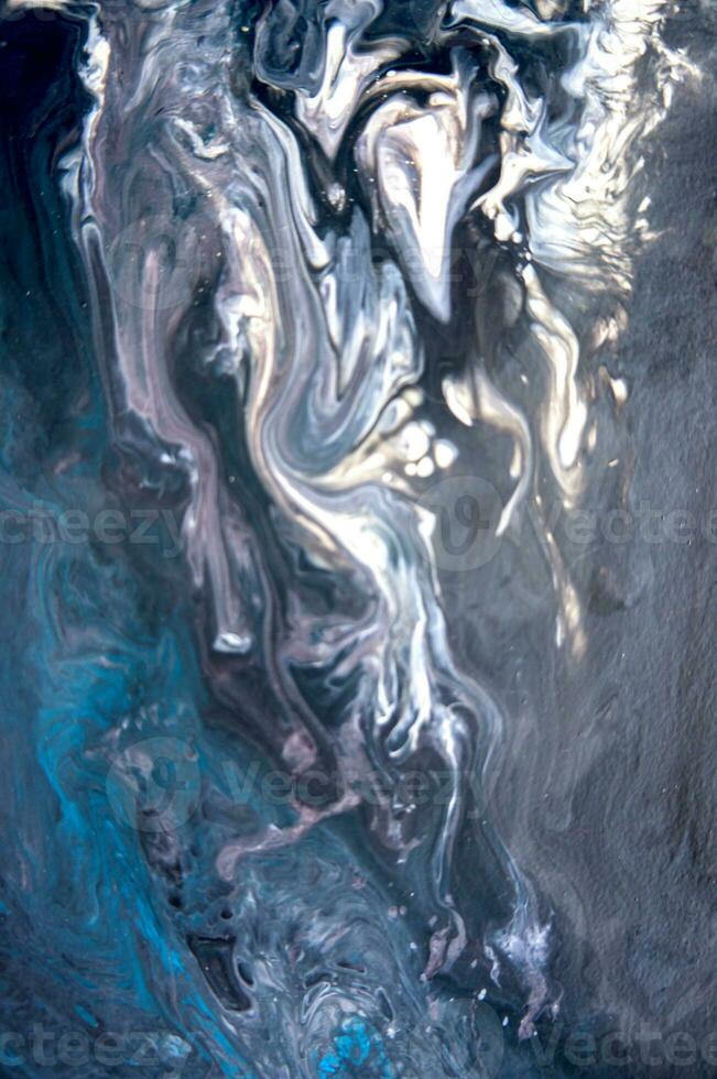 Abstract created using the technique of liquid acrylic. Macro photography of the smallest details of a picture. The picture shows how overflows of shades and colors of paint resemble space motifs. photo