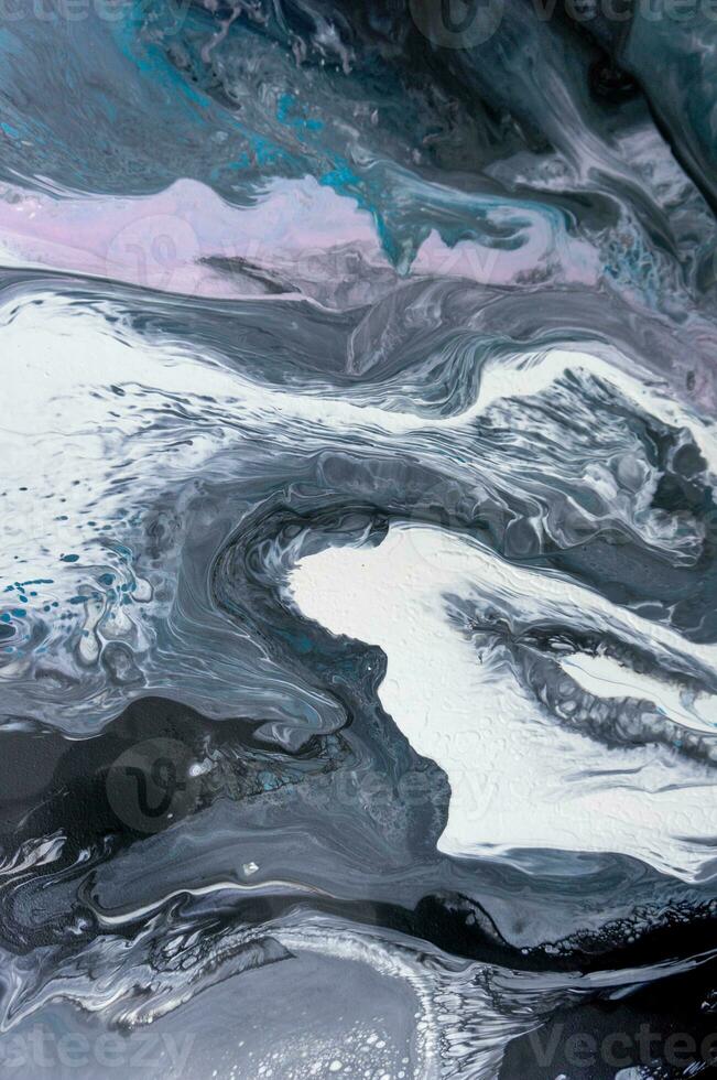 Abstract created using the technique of liquid acrylic. Macro photography of the smallest details of a picture. The picture shows how overflows of shades and colors of paint resemble space motifs. photo
