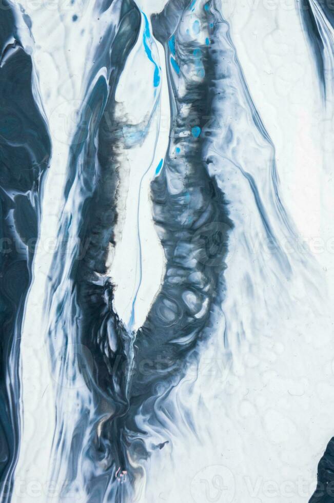 Abstract created using the technique of liquid acrylic. Macro photography of the smallest details of a picture. The picture shows how overflows of shades and colors of paint resemble space motifs. photo