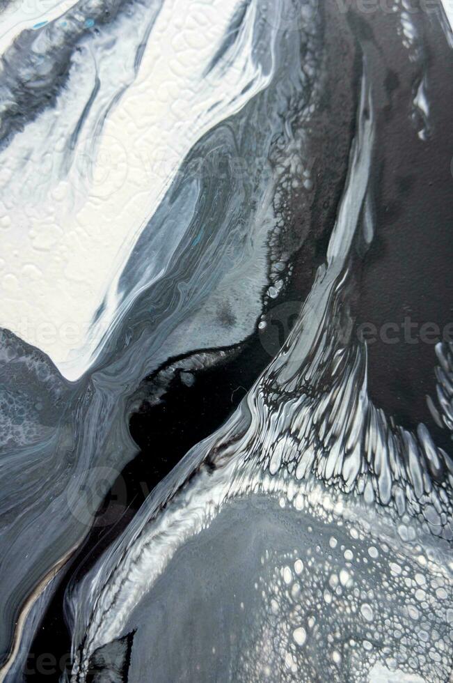 Abstract created using the technique of liquid acrylic. Macro photography of the smallest details of a picture. The picture shows how overflows of shades and colors of paint resemble space motifs. photo