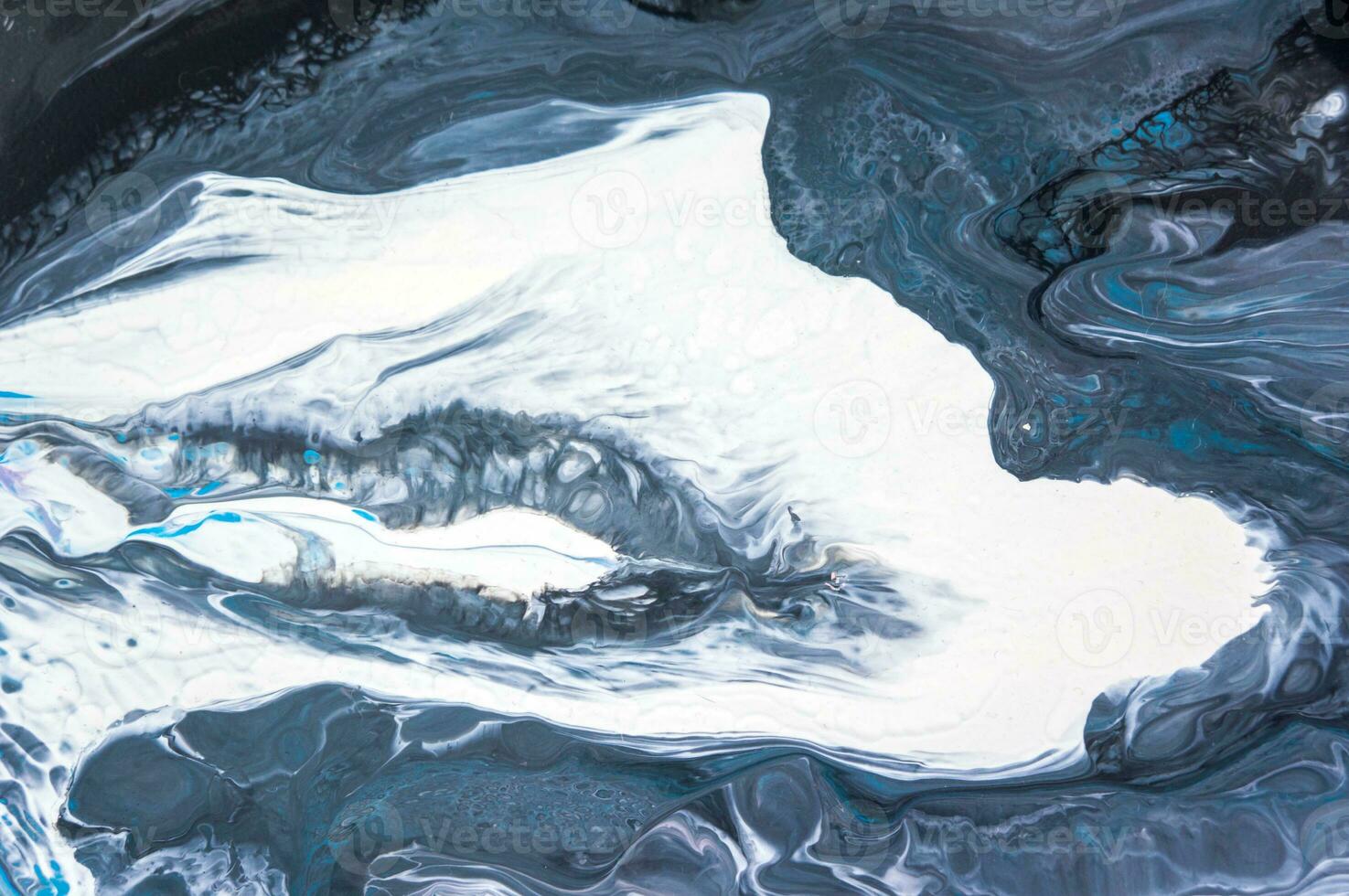 Abstract created using the technique of liquid acrylic. Macro photography of the smallest details of a picture. The picture shows how overflows of shades and colors of paint resemble space motifs. photo