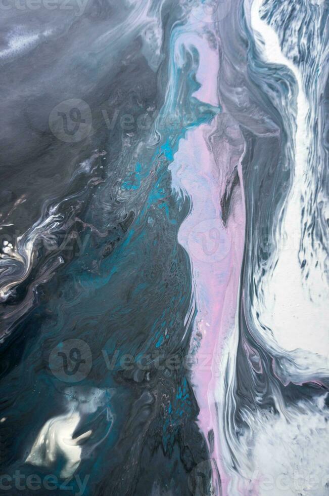 Abstract created using the technique of liquid acrylic. Macro photography of the smallest details of a picture. The picture shows how overflows of shades and colors of paint resemble space motifs. photo