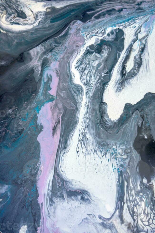 Abstract created using the technique of liquid acrylic. Macro photography of the smallest details of a picture. The picture shows how overflows of shades and colors of paint resemble space motifs. photo
