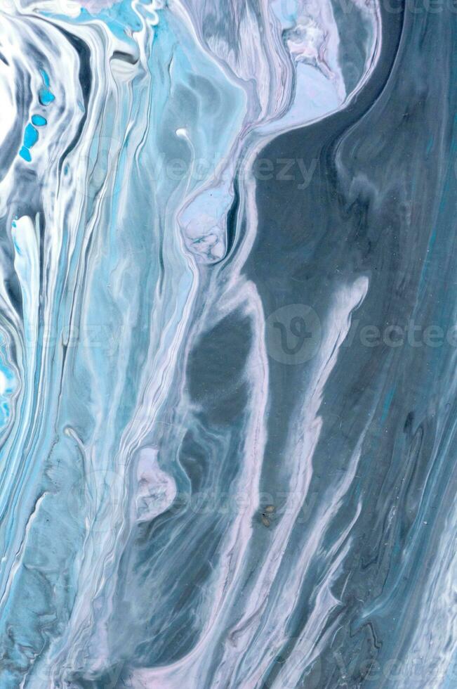 Abstract created using the technique of liquid acrylic. Macro photography of the smallest details of a picture. The picture shows how overflows of shades and colors of paint resemble space motifs. photo