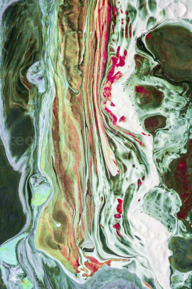 Abstract created using the technique of liquid acrylic. Macro photography of the smallest details of a picture. The picture shows how overflows of shades and colors of paint resemble space motifs. photo