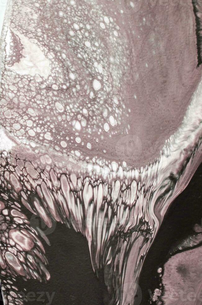 Abstract created using the technique of liquid acrylic. Macro photography of the smallest details of a picture. The picture shows how overflows of shades and colors of paint resemble space motifs. photo