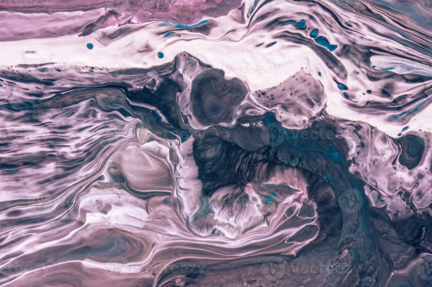 Abstract created using the technique of liquid acrylic. Macro photography of the smallest details of a picture. The picture shows how overflows of shades and colors of paint resemble space motifs. photo