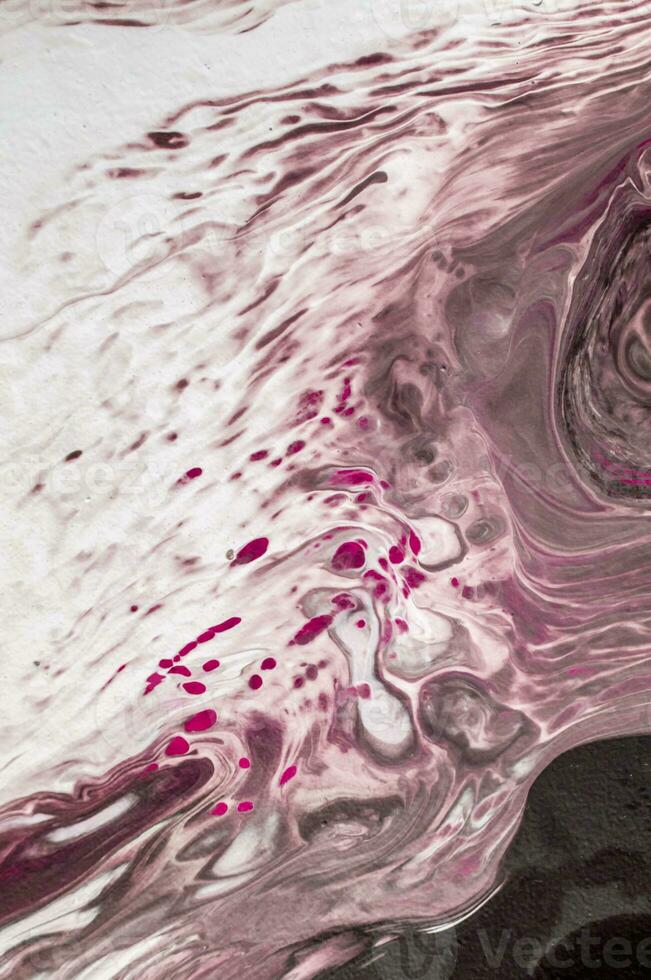 Abstract created using the technique of liquid acrylic. Macro photography of the smallest details of a picture. The picture shows how overflows of shades and colors of paint resemble space motifs. photo