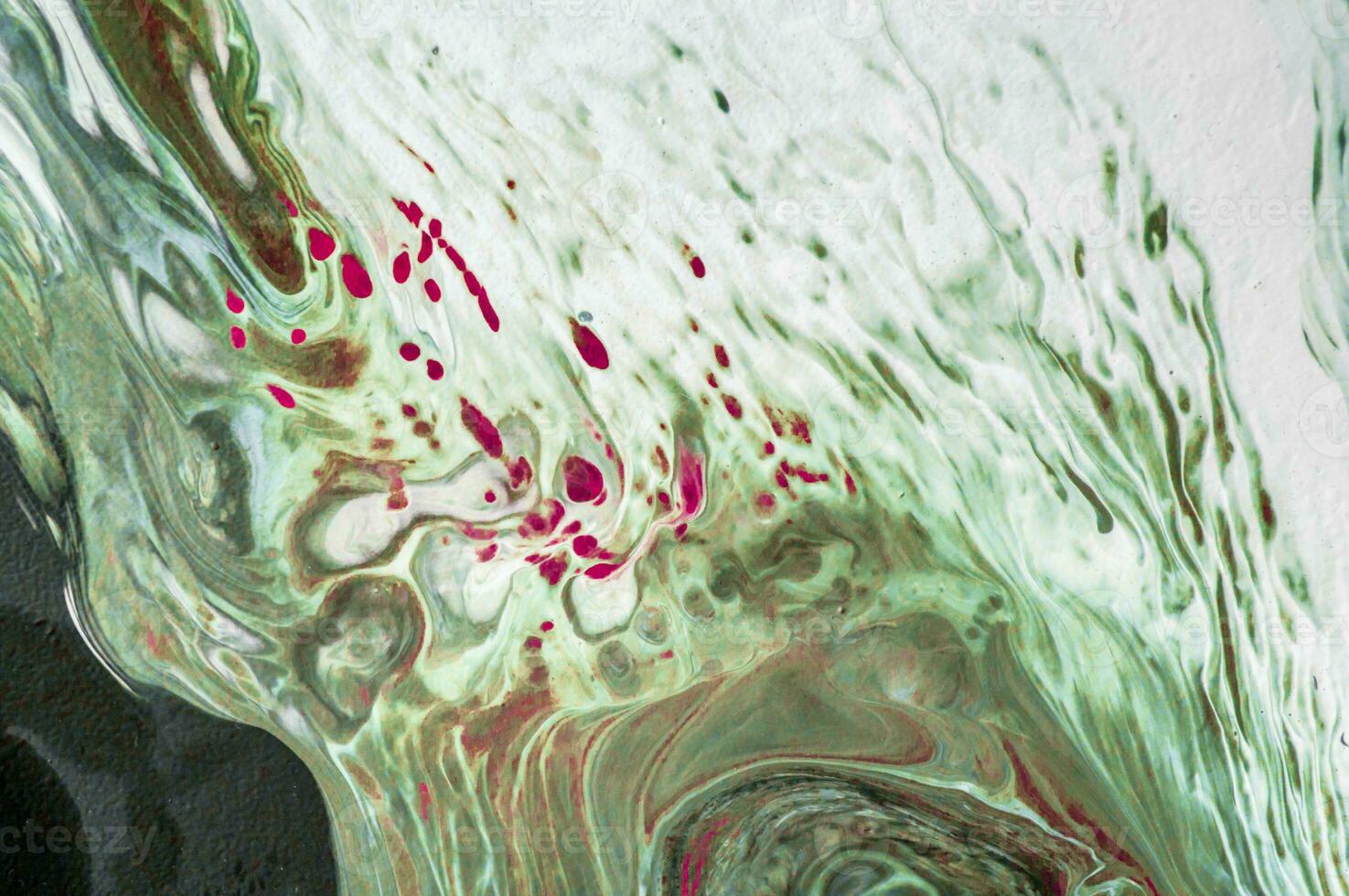 Abstract created using the technique of liquid acrylic. Macro photography of the smallest details of a picture. The picture shows how overflows of shades and colors of paint resemble space motifs. photo