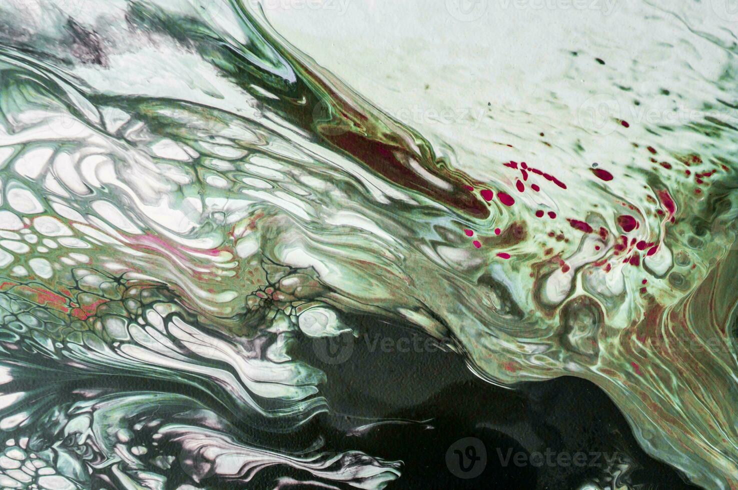 Abstract created using the technique of liquid acrylic. Macro photography of the smallest details of a picture. The picture shows how overflows of shades and colors of paint resemble space motifs. photo