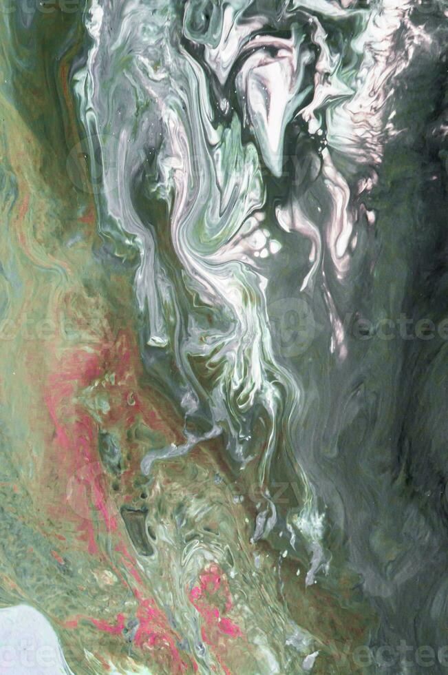 Abstract created using the technique of liquid acrylic. Macro photography of the smallest details of a picture. The picture shows how overflows of shades and colors of paint resemble space motifs. photo