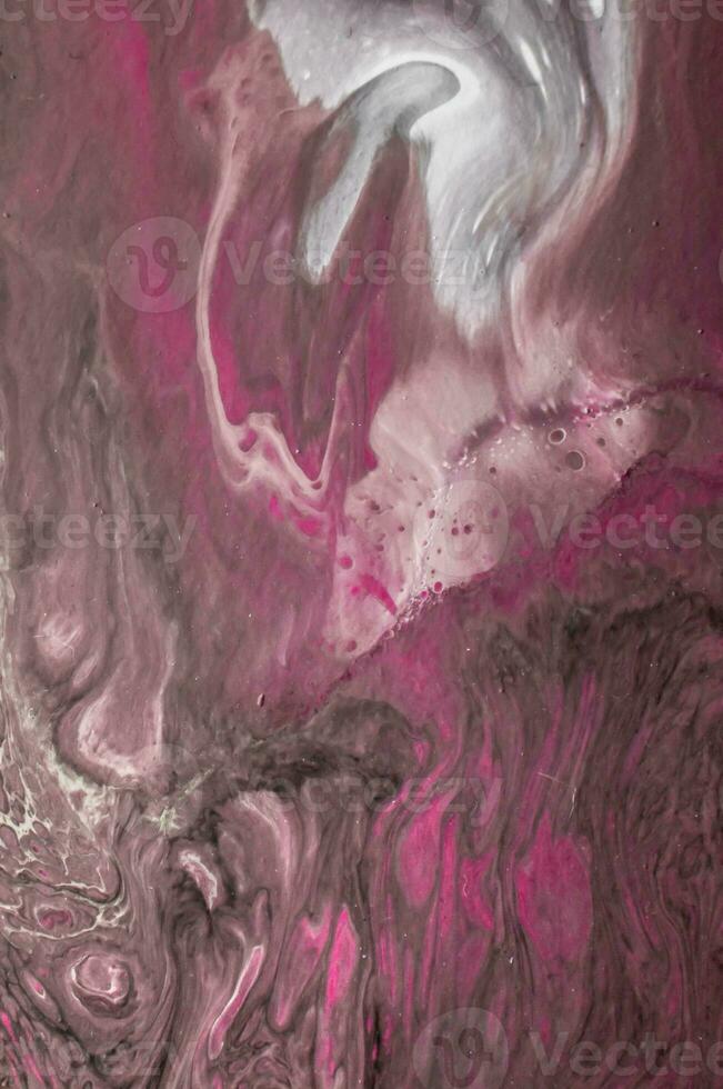 Abstract created using the technique of liquid acrylic. Macro photography of the smallest details of a picture. The picture shows how overflows of shades and colors of paint resemble space motifs. photo