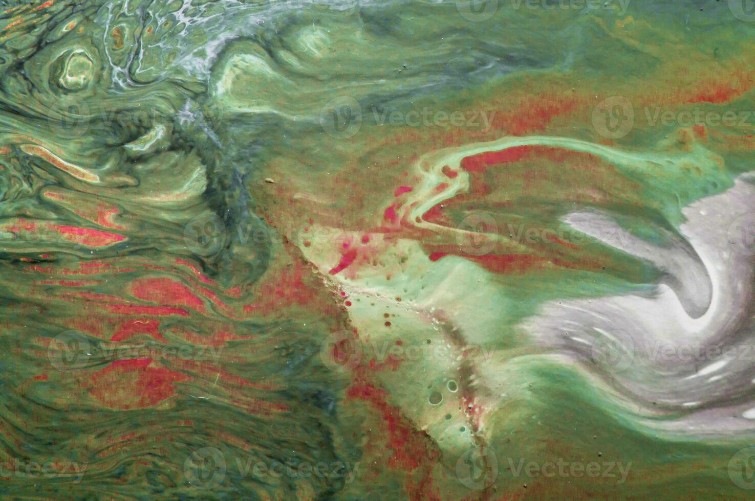 Abstract created using the technique of liquid acrylic. Macro photography of the smallest details of a picture. The picture shows how overflows of shades and colors of paint resemble space motifs. photo