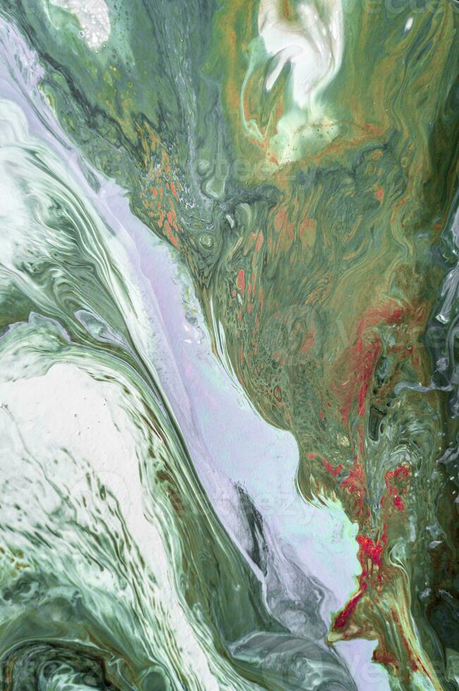 Abstract created using the technique of liquid acrylic. Macro photography of the smallest details of a picture. The picture shows how overflows of shades and colors of paint resemble space motifs. photo