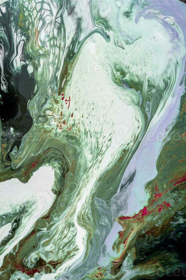 Abstract created using the technique of liquid acrylic. Macro photography of the smallest details of a picture. The picture shows how overflows of shades and colors of paint resemble space motifs. photo