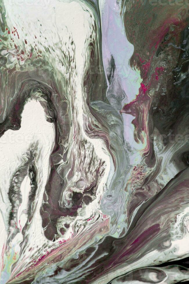 Abstract created using the technique of liquid acrylic. Macro photography of the smallest details of a picture. The picture shows how overflows of shades and colors of paint resemble space motifs. photo