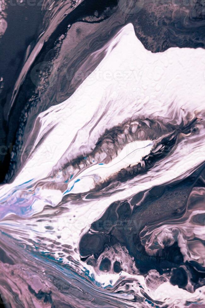 Abstract created using the technique of liquid acrylic. Macro photography of the smallest details of a picture. The picture shows how overflows of shades and colors of paint resemble space motifs. photo