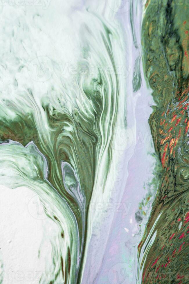 Abstract created using the technique of liquid acrylic. Macro photography of the smallest details of a picture. The picture shows how overflows of shades and colors of paint resemble space motifs. photo