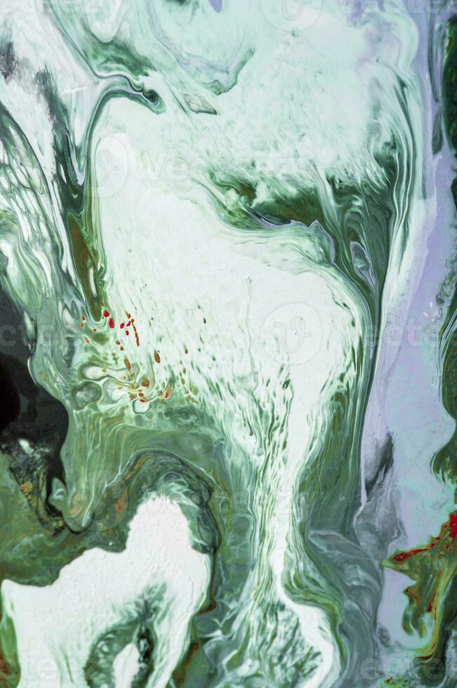 Abstract created using the technique of liquid acrylic. Macro photography of the smallest details of a picture. The picture shows how overflows of shades and colors of paint resemble space motifs. photo