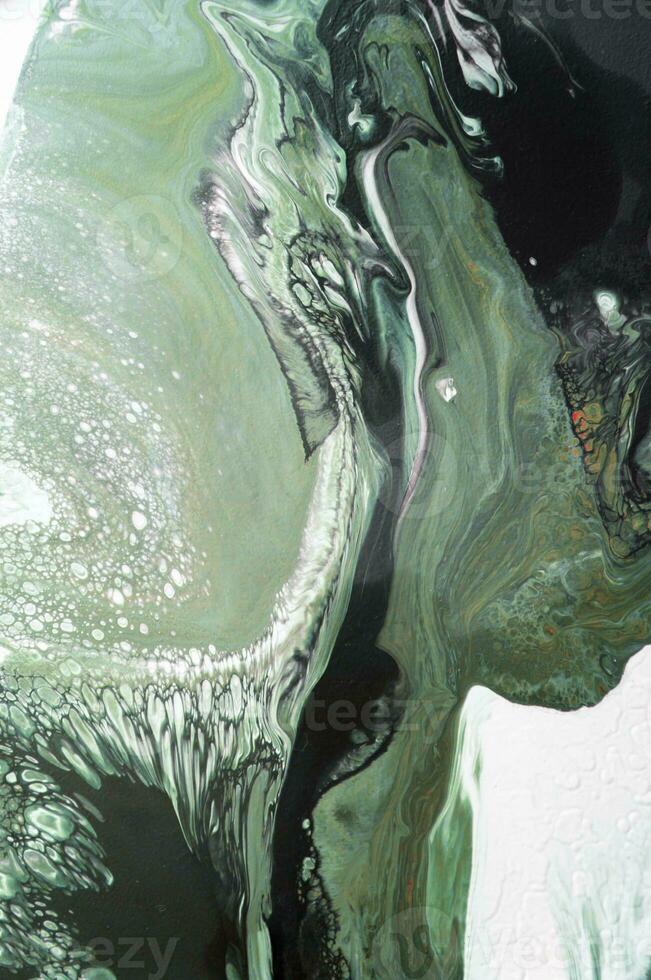 Abstract created using the technique of liquid acrylic. Macro photography of the smallest details of a picture. The picture shows how overflows of shades and colors of paint resemble space motifs. photo