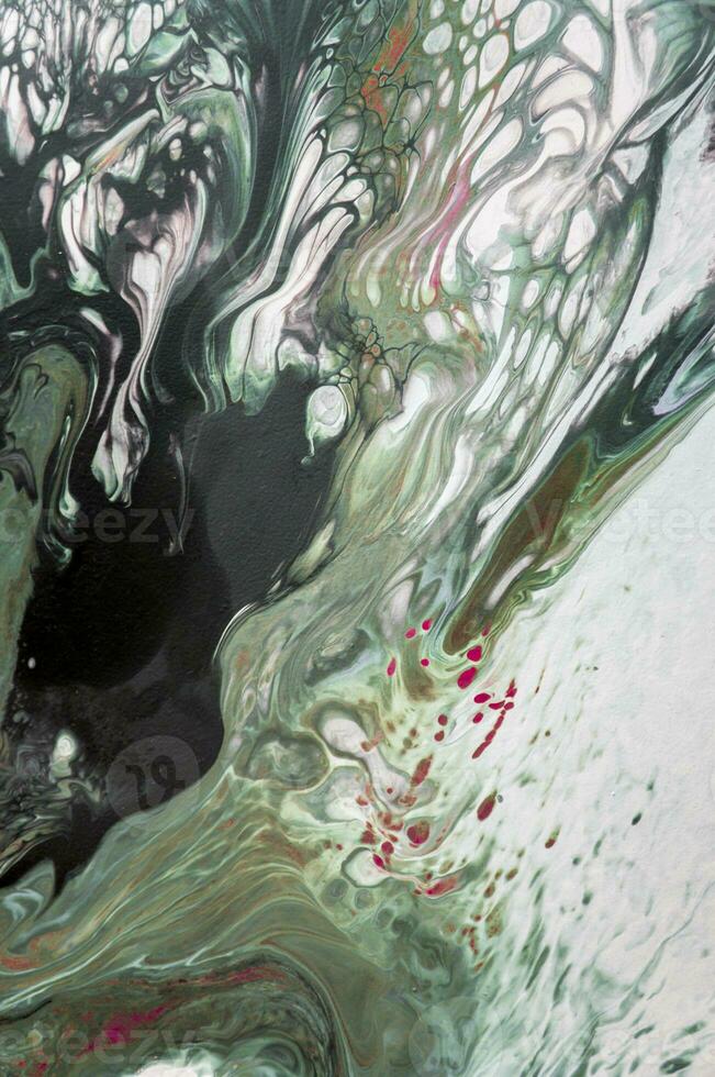 Abstract created using the technique of liquid acrylic. Macro photography of the smallest details of a picture. The picture shows how overflows of shades and colors of paint resemble space motifs. photo