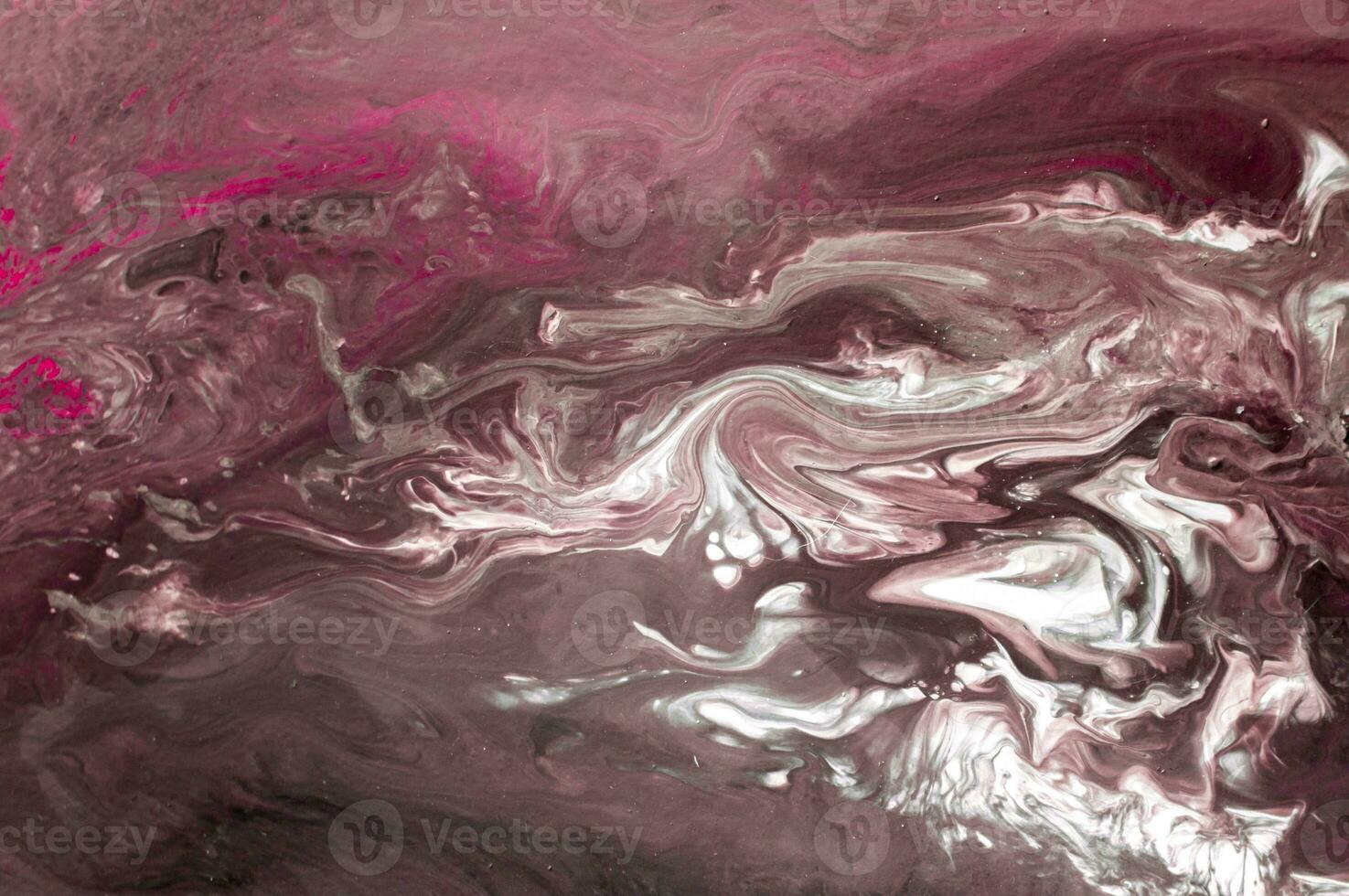 Abstract created using the technique of liquid acrylic. Macro photography of the smallest details of a picture. The picture shows how overflows of shades and colors of paint resemble space motifs. photo