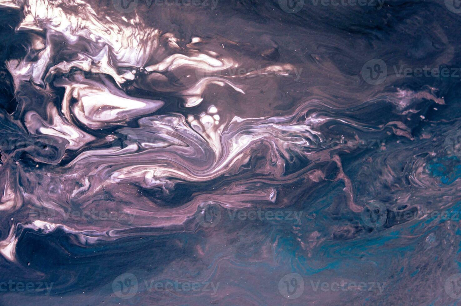 Abstract created using the technique of liquid acrylic. Macro photography of the smallest details of a picture. The picture shows how overflows of shades and colors of paint resemble space motifs. photo