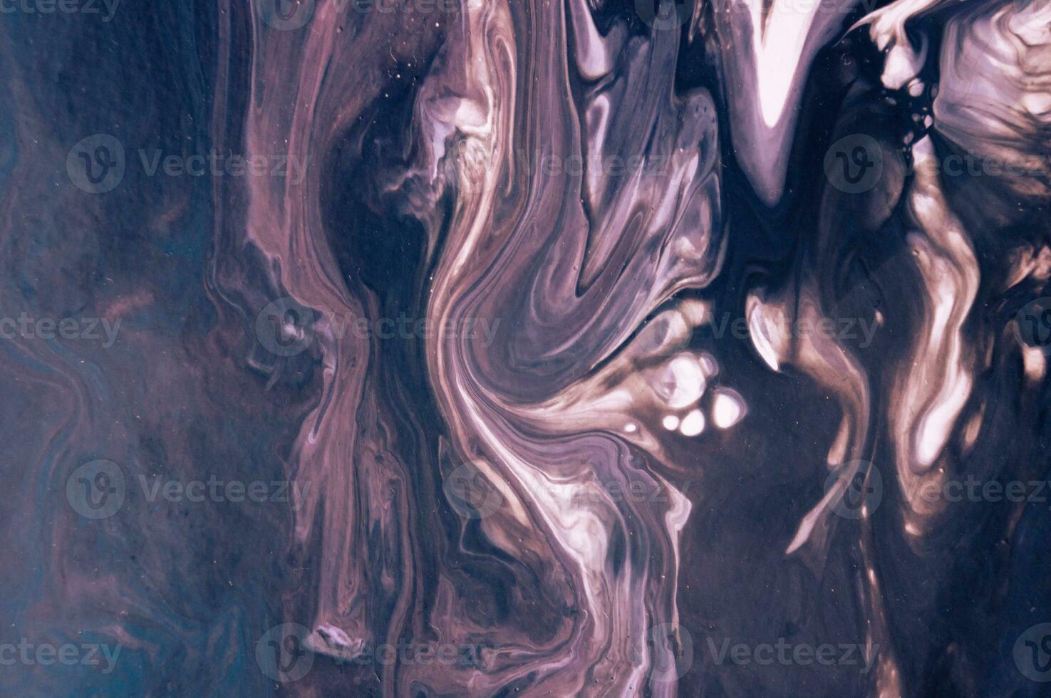 Abstract created using the technique of liquid acrylic. Macro photography of the smallest details of a picture. The picture shows how overflows of shades and colors of paint resemble space motifs. photo