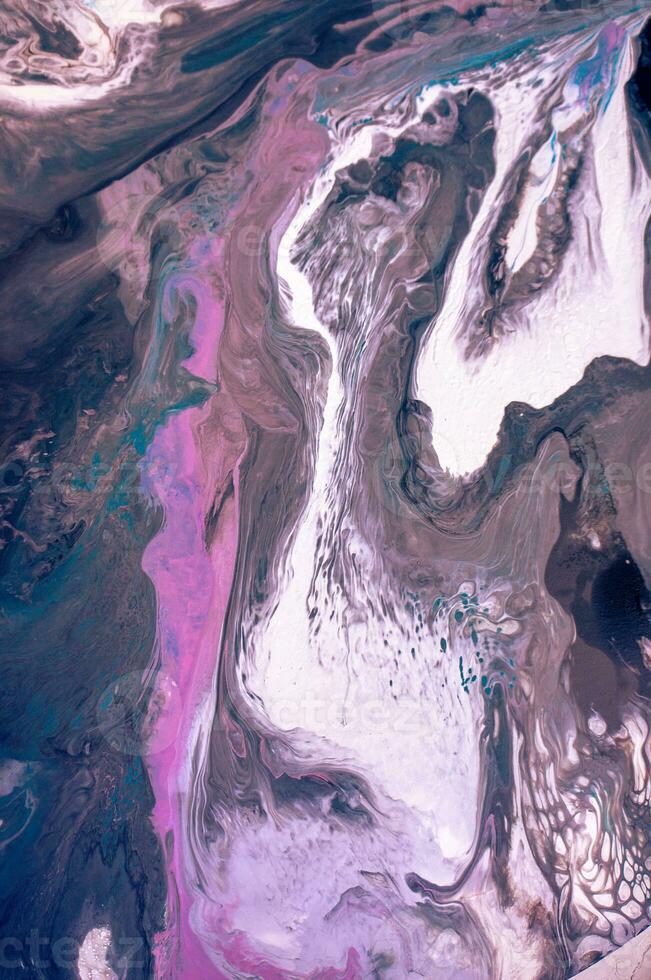 Abstract created using the technique of liquid acrylic. Macro photography of the smallest details of a picture. The picture shows how overflows of shades and colors of paint resemble space motifs. photo