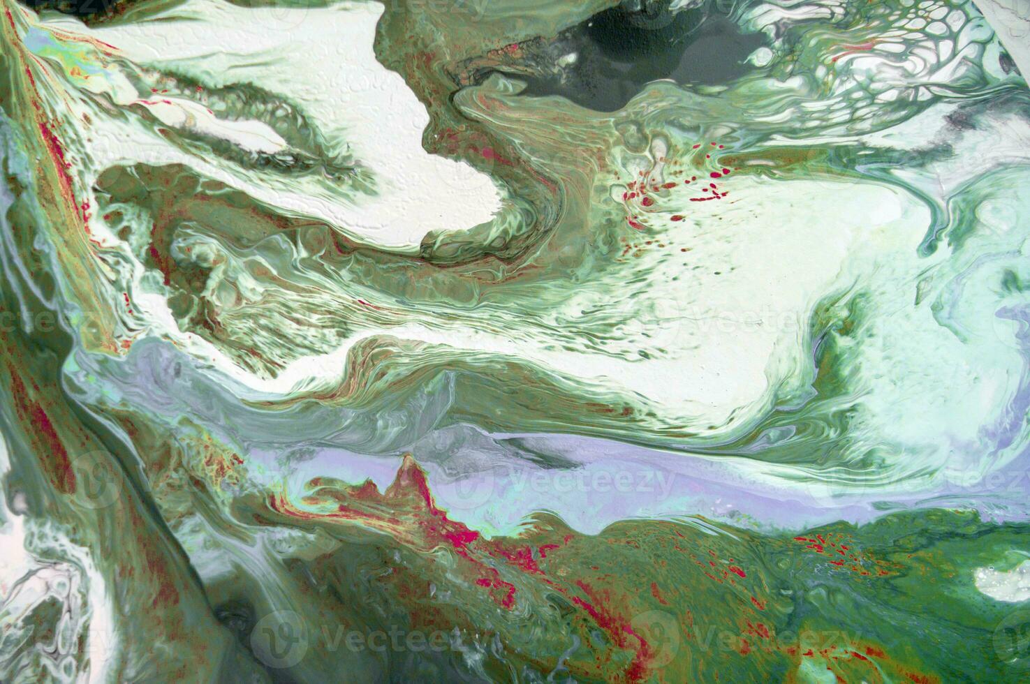 Abstract created using the technique of liquid acrylic. Macro photography of the smallest details of a picture. The picture shows how overflows of shades and colors of paint resemble space motifs. photo