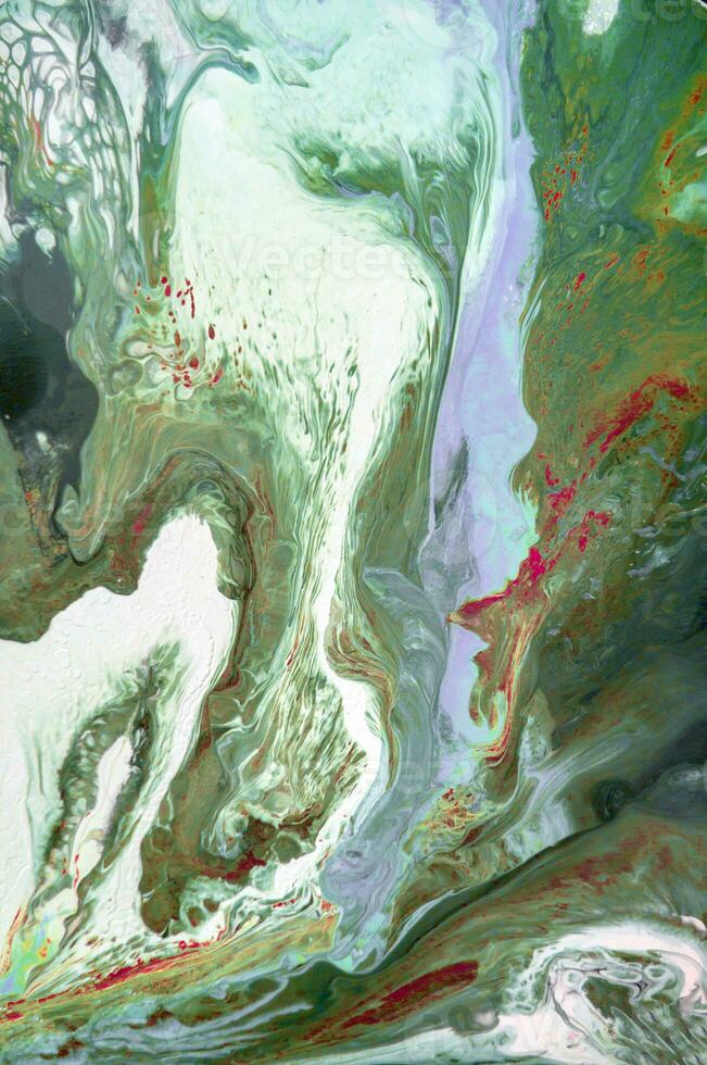 Abstract created using the technique of liquid acrylic. Macro photography of the smallest details of a picture. The picture shows how overflows of shades and colors of paint resemble space motifs. photo