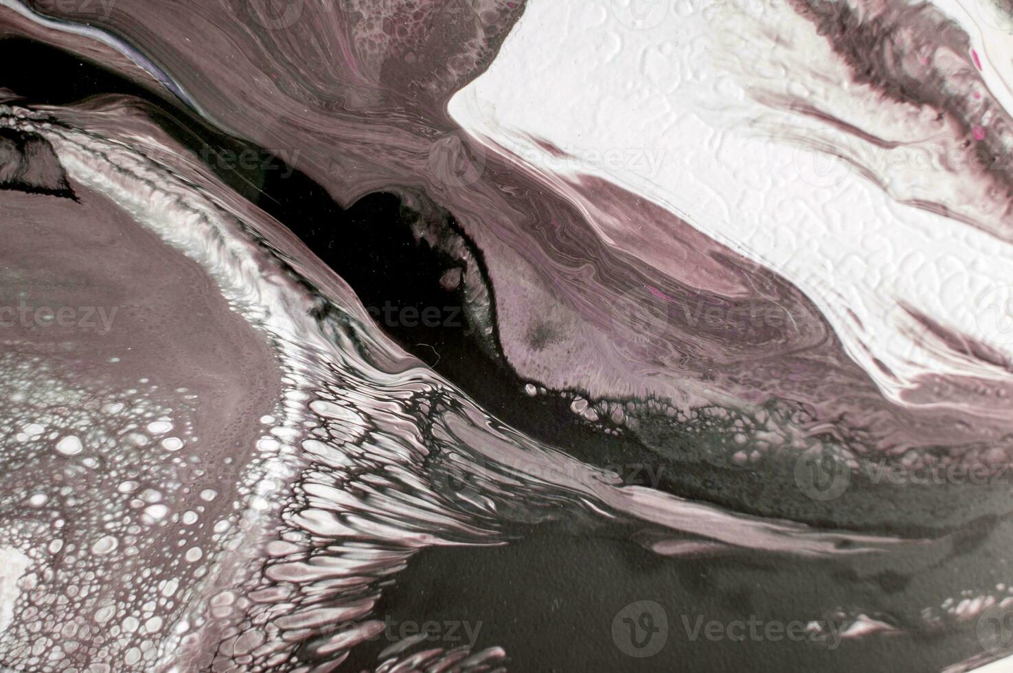 Abstract created using the technique of liquid acrylic. Macro photography of the smallest details of a picture. The picture shows how overflows of shades and colors of paint resemble space motifs. photo