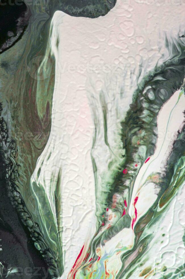 Abstract created using the technique of liquid acrylic. Macro photography of the smallest details of a picture. The picture shows how overflows of shades and colors of paint resemble space motifs. photo