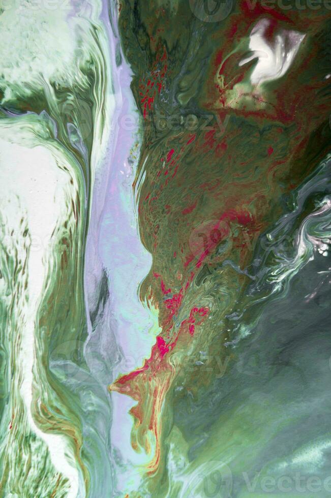 Abstract created using the technique of liquid acrylic. Macro photography of the smallest details of a picture. The picture shows how overflows of shades and colors of paint resemble space motifs. photo