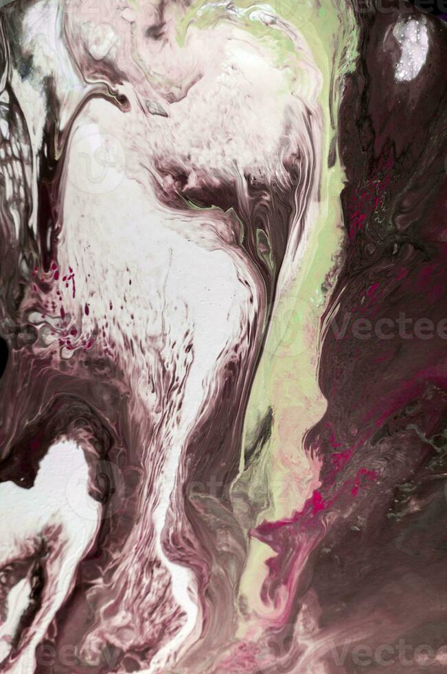 Abstract created using the technique of liquid acrylic. Macro photography of the smallest details of a picture. The picture shows how overflows of shades and colors of paint resemble space motifs. photo