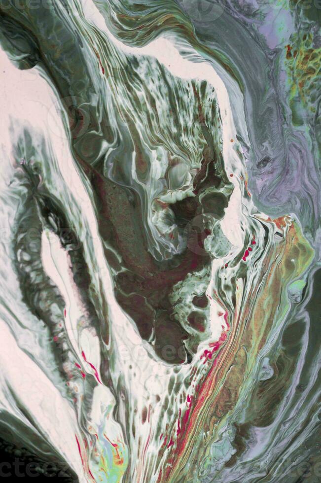 Abstract created using the technique of liquid acrylic. Macro photography of the smallest details of a picture. The picture shows how overflows of shades and colors of paint resemble space motifs. photo