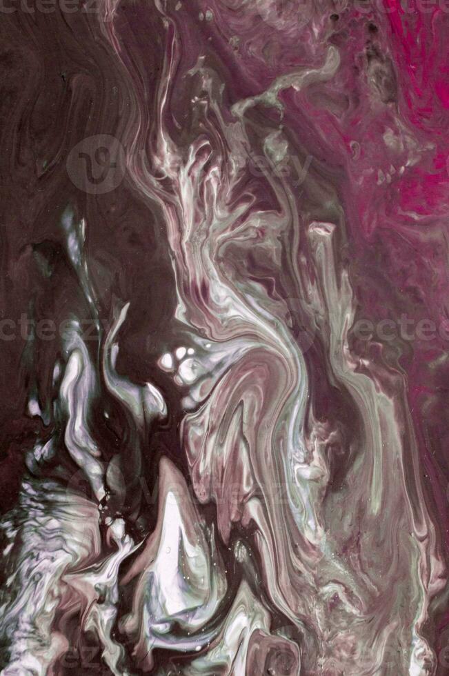 Abstract created using the technique of liquid acrylic. Macro photography of the smallest details of a picture. The picture shows how overflows of shades and colors of paint resemble space motifs. photo