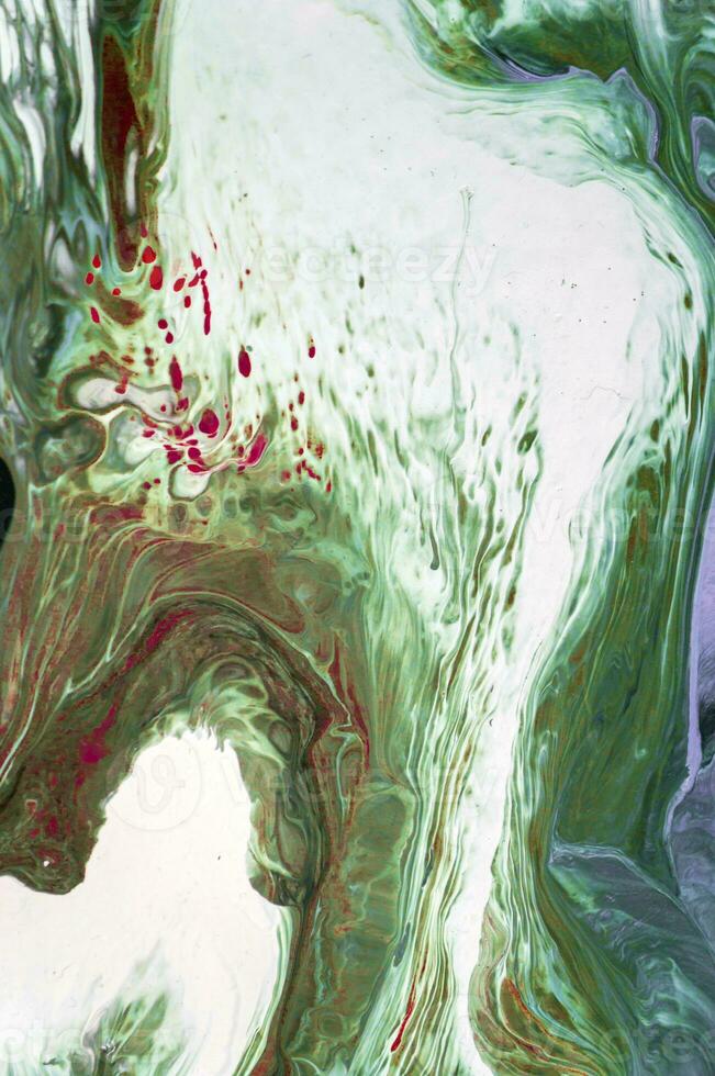 Abstract created using the technique of liquid acrylic. Macro photography of the smallest details of a picture. The picture shows how overflows of shades and colors of paint resemble space motifs. photo