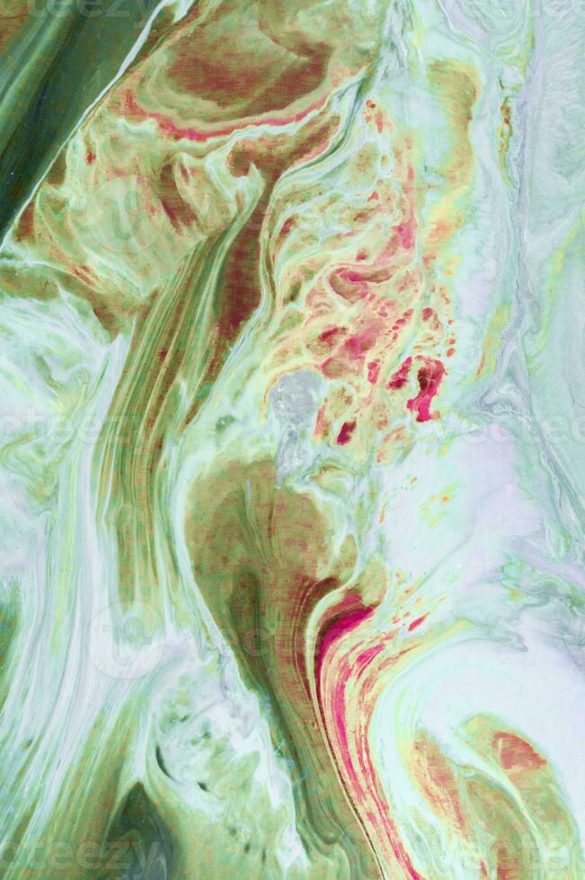Abstract created using the technique of liquid acrylic. Macro photography of the smallest details of a picture. The picture shows how overflows of shades and colors of paint resemble space motifs. photo