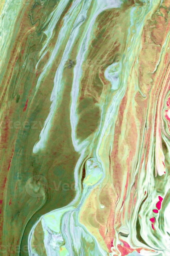 Abstract created using the technique of liquid acrylic. Macro photography of the smallest details of a picture. The picture shows how overflows of shades and colors of paint resemble space motifs. photo