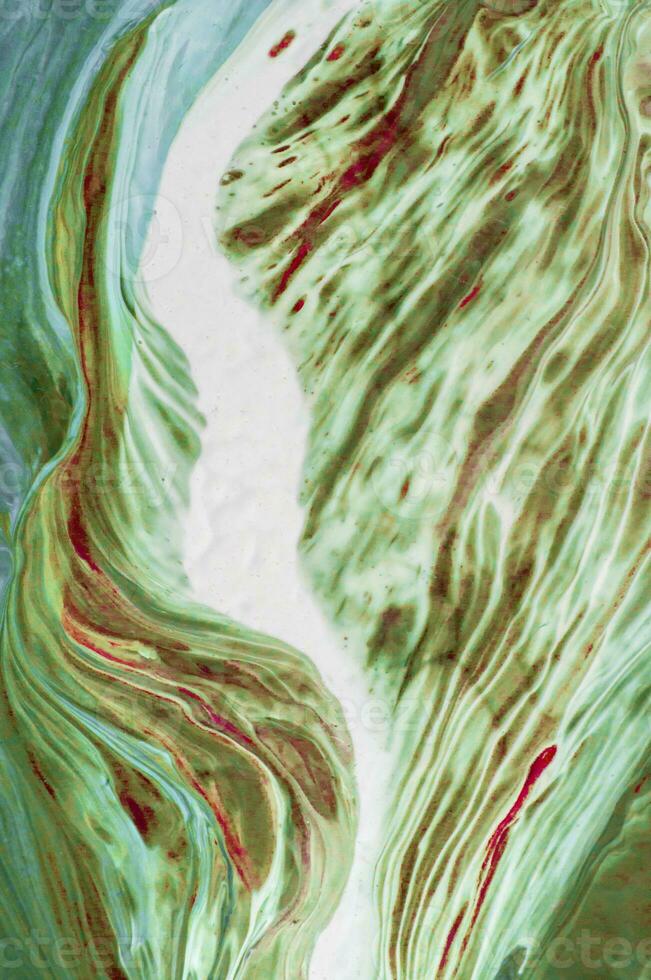 Abstract created using the technique of liquid acrylic. Macro photography of the smallest details of a picture. The picture shows how overflows of shades and colors of paint resemble space motifs. photo
