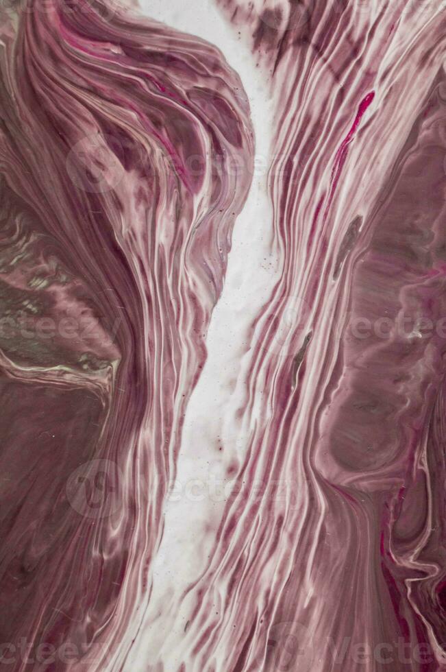 Abstract created using the technique of liquid acrylic. Macro photography of the smallest details of a picture. The picture shows how overflows of shades and colors of paint resemble space motifs. photo