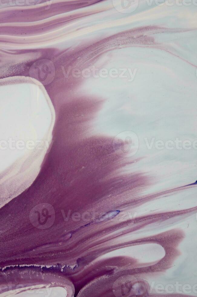 Abstract created using the technique of liquid acrylic. Macro photography of the smallest details of a panting. The panting shows how overflows of shades and colors of paint resemble space motifs. photo