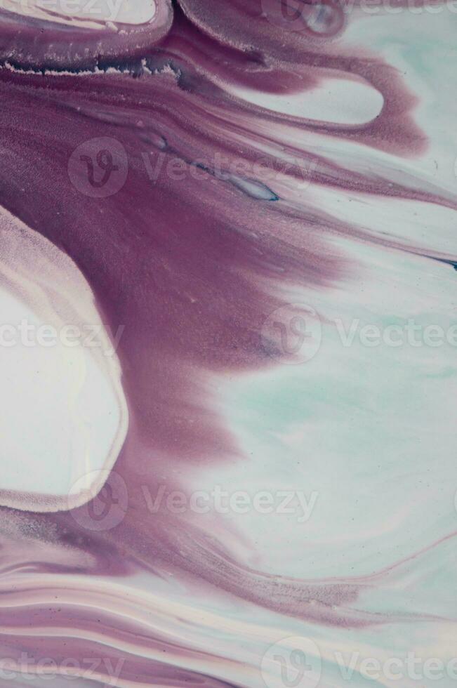 Abstract created using the technique of liquid acrylic. Macro photography of the smallest details of a panting. The panting shows how overflows of shades and colors of paint resemble space motifs. photo