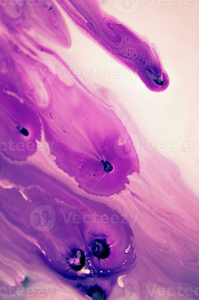 Abstract created using the technique of liquid acrylic. Macro photography of the smallest details of a panting. The panting shows how overflows of shades and colors of paint resemble space motifs. photo