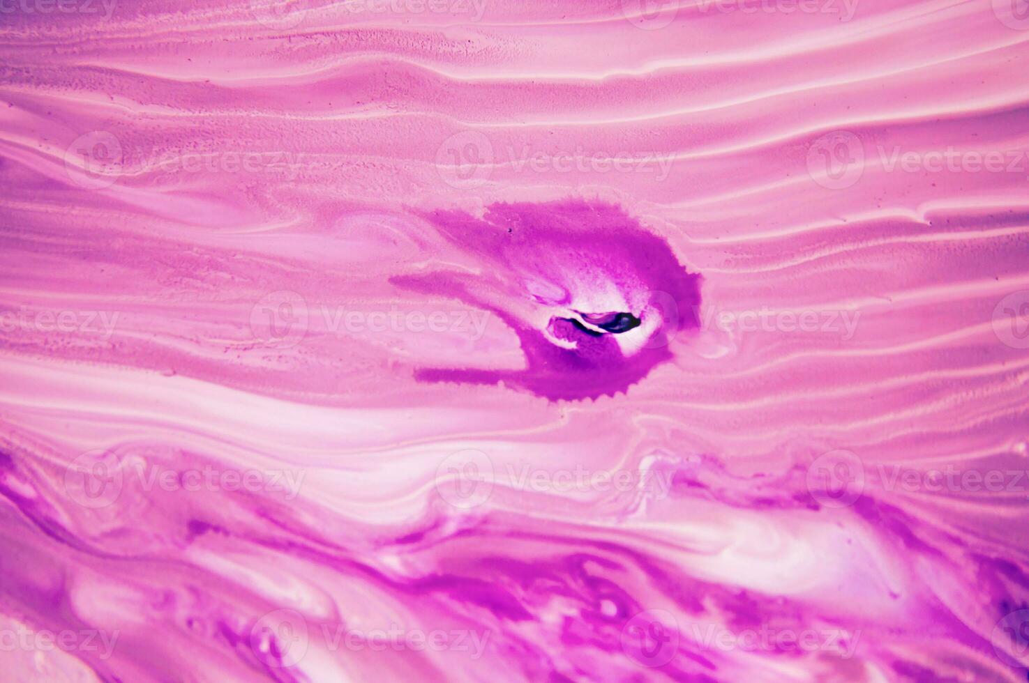 Abstract created using the technique of liquid acrylic. Macro photography of the smallest details of a panting. The panting shows how overflows of shades and colors of paint resemble space motifs. photo