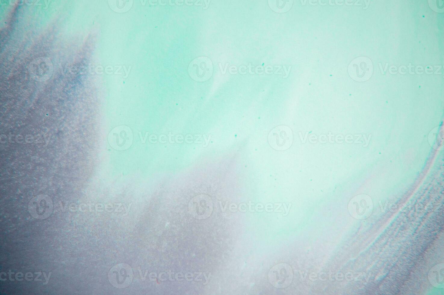 Abstract created using the technique of liquid acrylic. Macro photography of the smallest details of a panting. The panting shows how overflows of shades and colors of paint resemble space motifs. photo