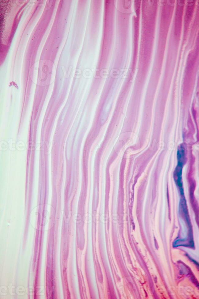 Abstract created using the technique of liquid acrylic. Macro photography of the smallest details of a panting. The panting shows how overflows of shades and colors of paint resemble space motifs. photo