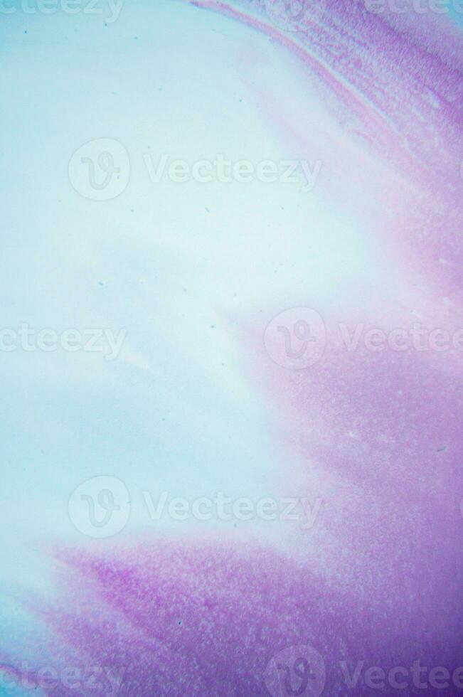 Abstract created using the technique of liquid acrylic. Macro photography of the smallest details of a panting. The panting shows how overflows of shades and colors of paint resemble space motifs. photo