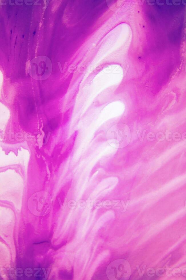 Abstract created using the technique of liquid acrylic. Macro photography of the smallest details of a panting. The panting shows how overflows of shades and colors of paint resemble space motifs. photo